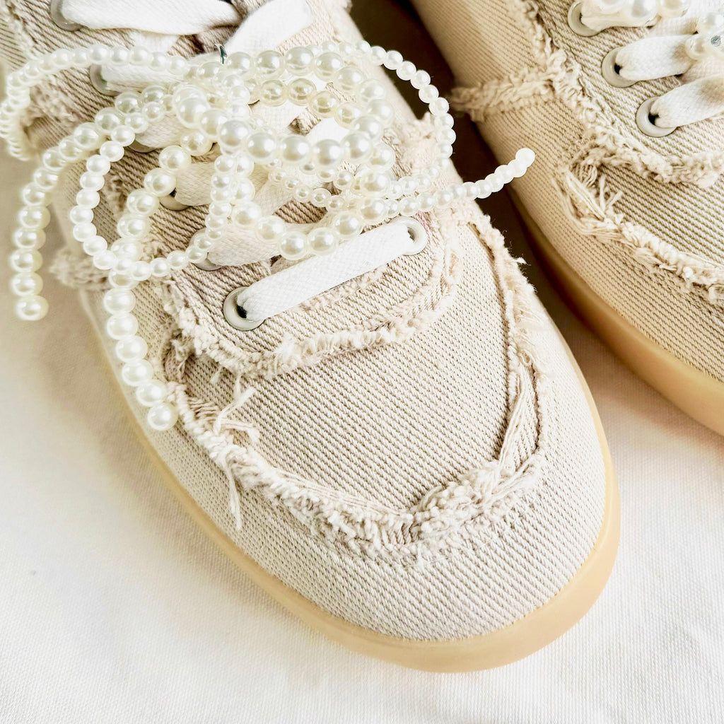 Close-up of MayMax Frayed Edge Canvas Sneaker frayed seam detail
