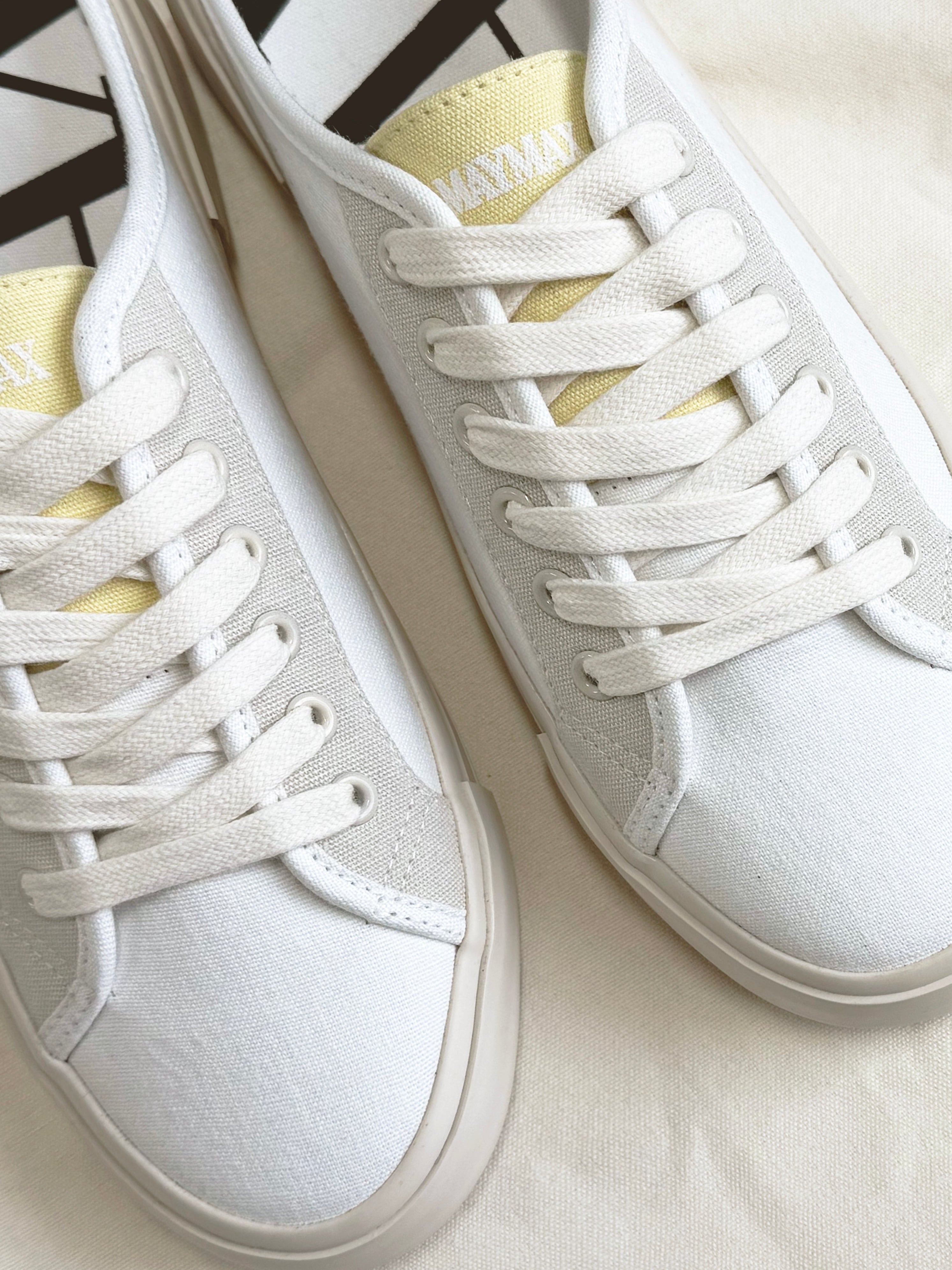 Close-up of MayMax White Canvas Mule Sneaker canvas texture